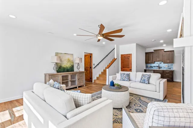 a living room with furniture and a ceiling fan