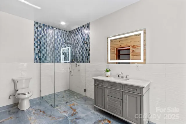 a bathroom with a sink toilet and mirror