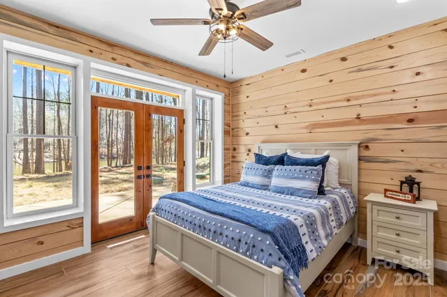 a bedroom with a large bed and a chandelier