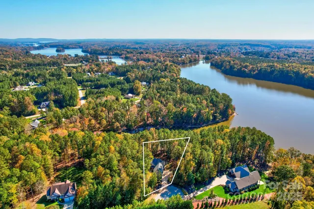 an aerial view of a residential houses with outdoor space and swimming pool