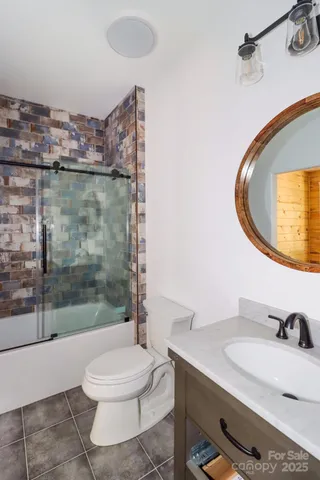 a bathroom with a sink a toilet and a mirror