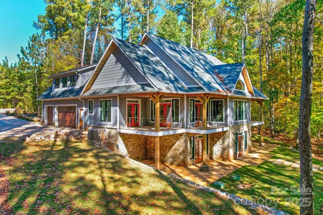 a view of a house with swimming pool and sitting area