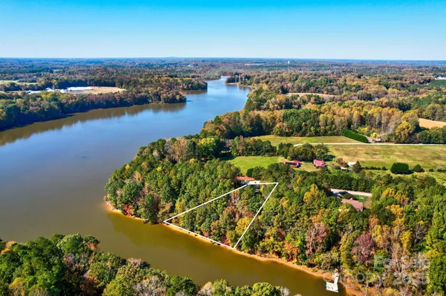 an aerial view of lake and residential houses with outdoor space
