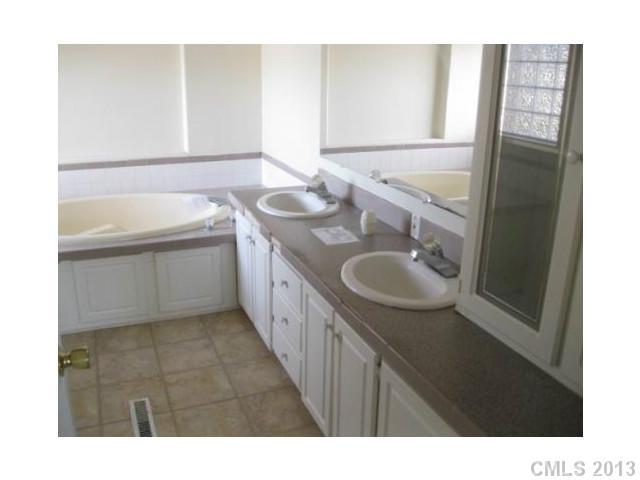 1756 Martin Road Kings Mountain, NC 28086 - Photo 7 of 12 a bathroom with a sink a mirror and a bathtub