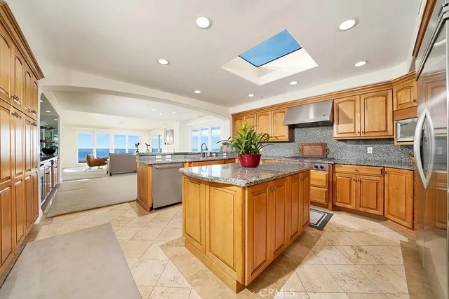 a kitchen with stainless steel appliances granite countertop a sink and cabinets