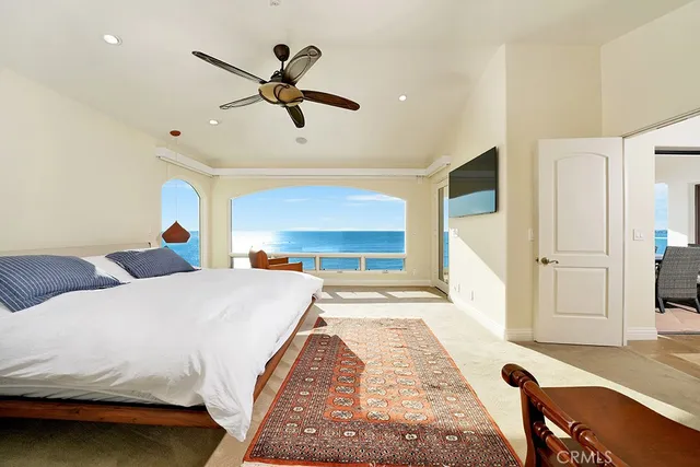 a bedroom with a bed and a large window