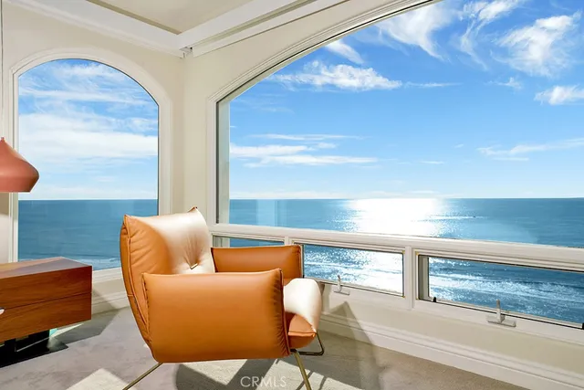 a living room with furniture and a floor to ceiling window