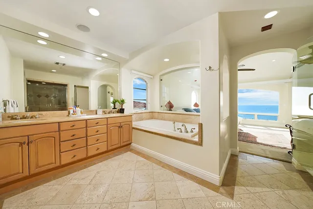 a large bathroom with a large mirror vanity and shower