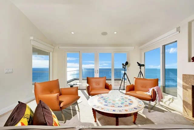 a bedroom with furniture and a large window