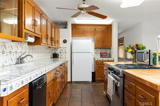 a kitchen with granite countertop cabinets stainless steel appliances a sink and a counter top space