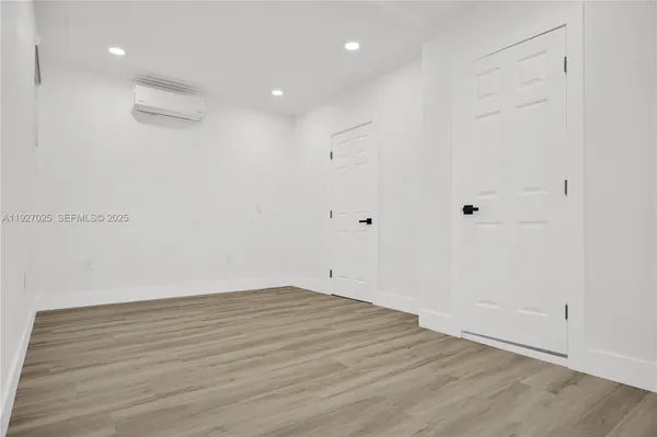 a view of room with wooden floor