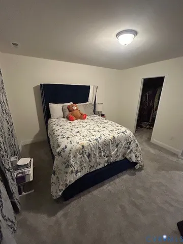 a bedroom with a bed and a night stand