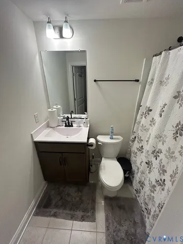a bathroom with a sink toilet and mirror