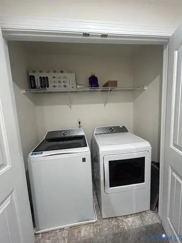 a view of washer and dryer with kitchen racks
