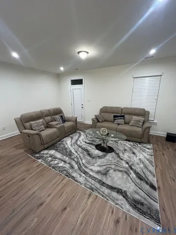 a bed room with furniture and a wooden floor