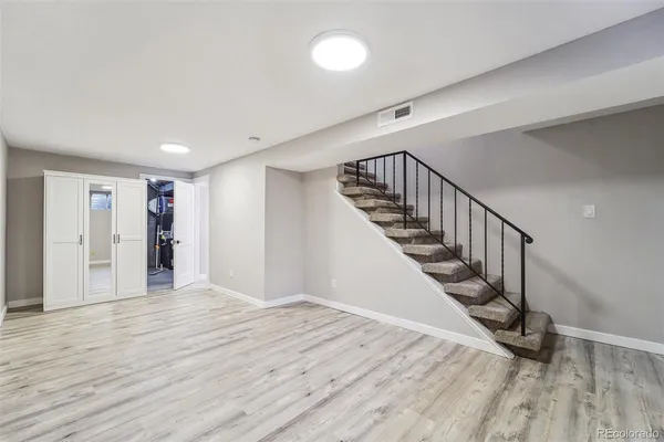 a view of an empty room with wooden floor
