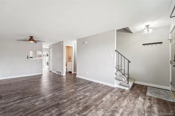 a view of empty room with wooden floor