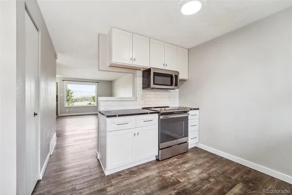 a kitchen with stainless steel appliances granite countertop a stove and a sink