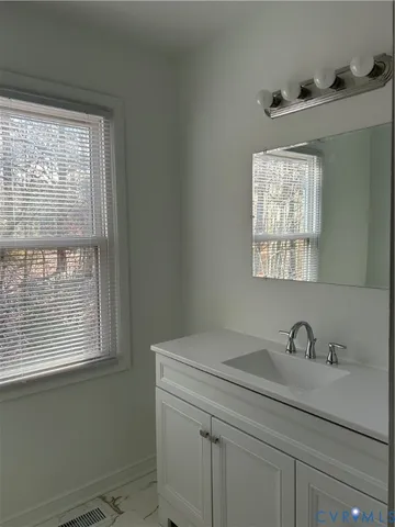 a bathroom with a sink and a window