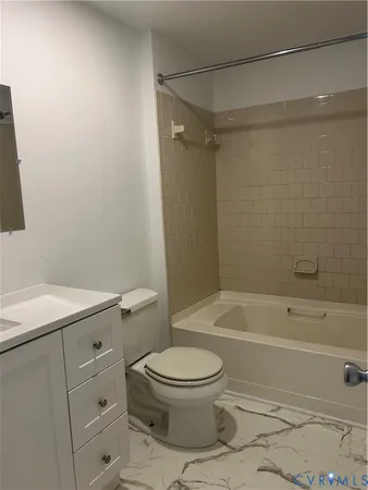 a bathroom with a toilet and a bathtub