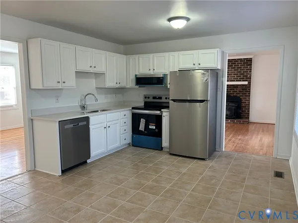 a kitchen with stainless steel appliances a refrigerator sink and cabinets