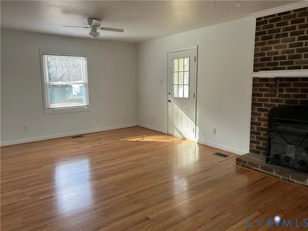 wooden floor in an empty room with a window