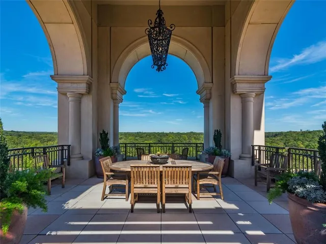 a view of a patio with table and chairs potted plants with wooden floor