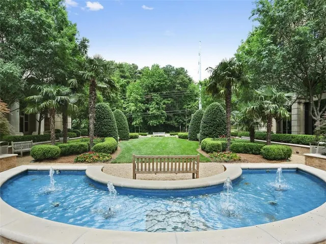 a view of a swimming pool with a patio and a garden