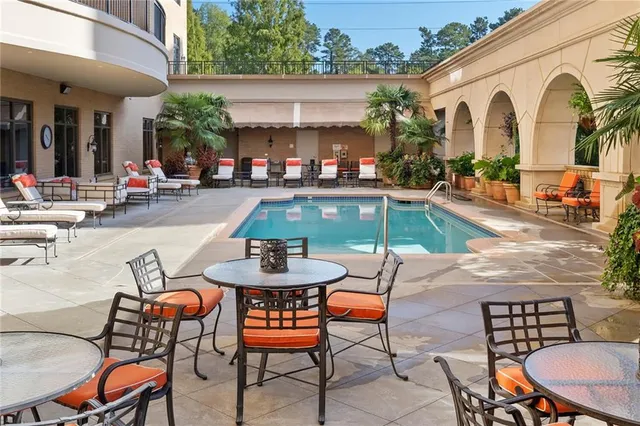 a view of a swimming pool with outdoor seating