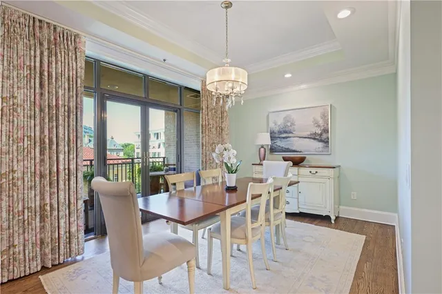 a dining room with furniture a chandelier and window
