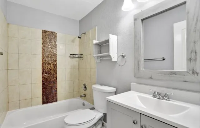 a bathroom with a sink toilet and shower