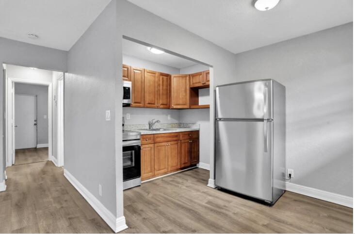 240 Southeast 9th Avenue, Unit 2 Pompano Beach, FL 33060 - Photo 4 of 17 a kitchen with stainless steel appliances granite countertop a refrigerator a microwave a sink and a cabinets