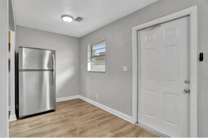 240 Southeast 9th Avenue, Unit 2 Pompano Beach, FL 33060 - Photo 5 of 17 a view of empty room with wooden floor and closet