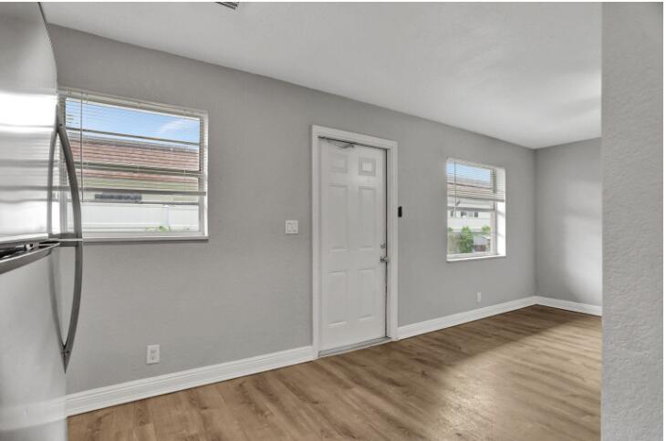 240 Southeast 9th Avenue, Unit 2 Pompano Beach, FL 33060 - Photo 6 of 17 a view of empty room with wooden floor and fan
