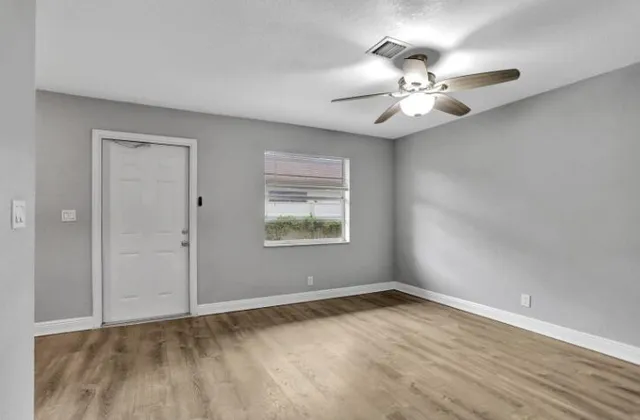 wooden floor in an empty room with a window