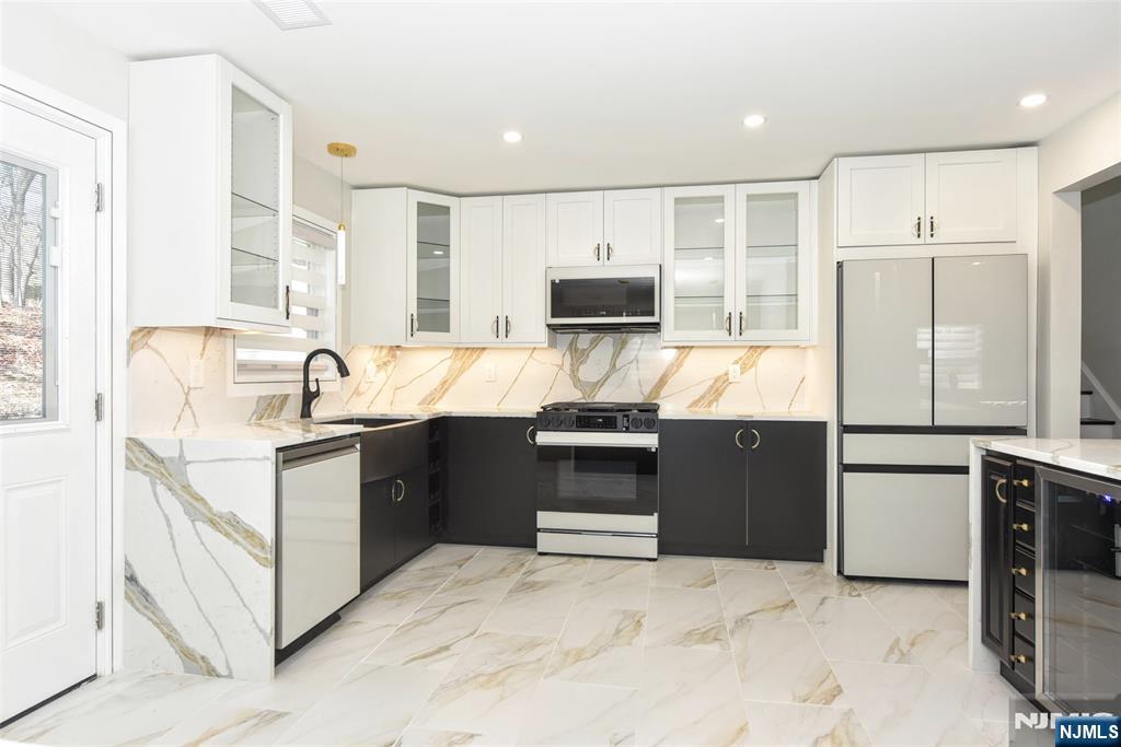 28 Overlook Road Saddle River, NJ 07458 - Photo 15 of 35 a large kitchen with stainless steel appliances granite countertop a stove a sink and a refrigerator