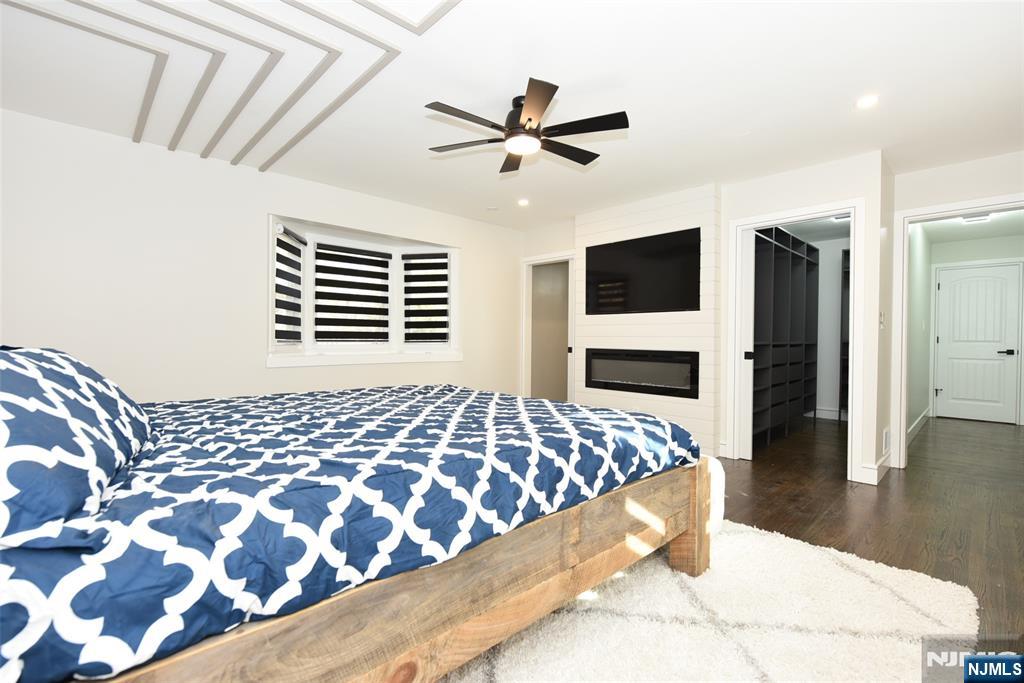 28 Overlook Road Saddle River, NJ 07458 - Photo 20 of 35 a bedroom with a bed and a flat tv screen on dresser