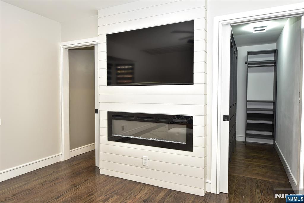 28 Overlook Road Saddle River, NJ 07458 - Photo 21 of 35 a living room with a fireplace and a flat screen tv