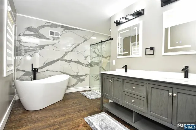 a living room with a couch and dresser with wooden floor