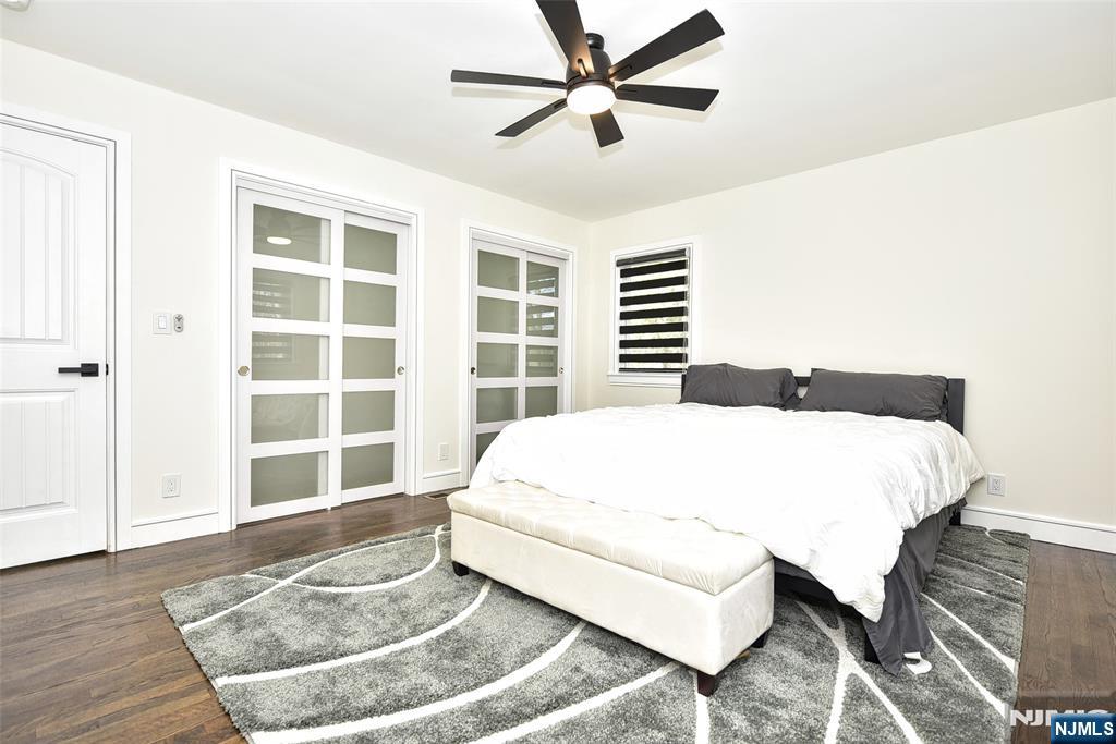 28 Overlook Road Saddle River, NJ 07458 - Photo 26 of 35 a large bed sitting in a bedroom next to a window and a chandelier