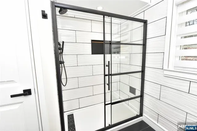 a bathroom with a glass shower door