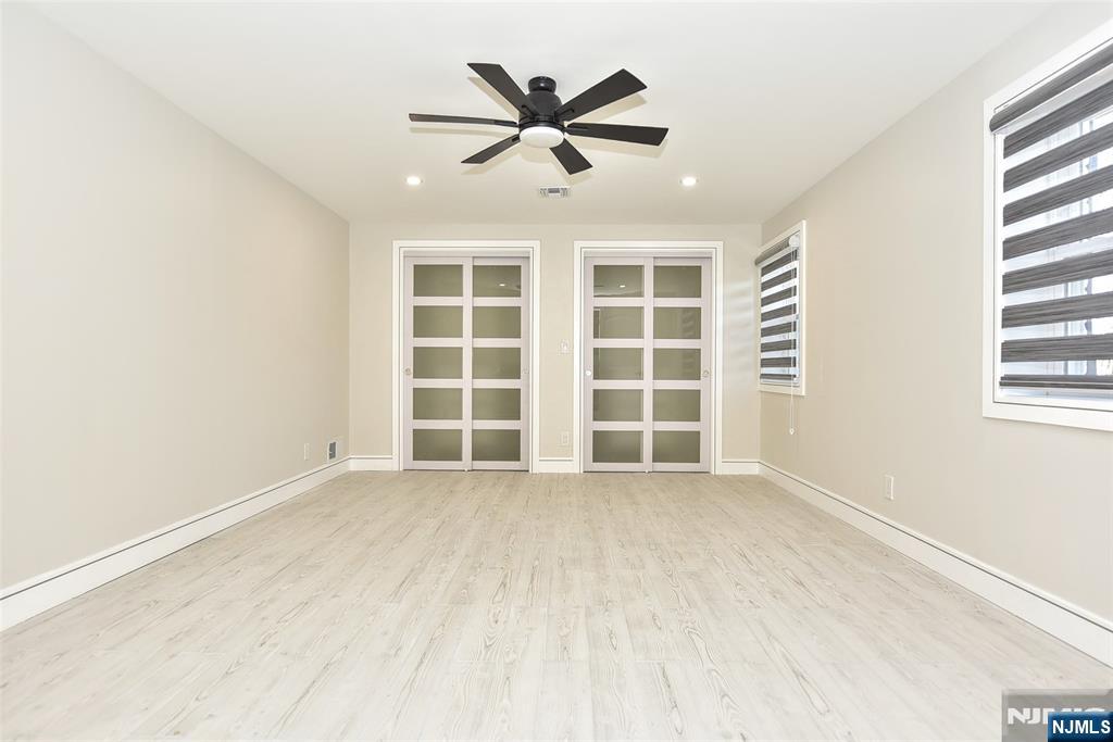 28 Overlook Road Saddle River, NJ 07458 - Photo 31 of 35 an empty room with windows and ceiling fan