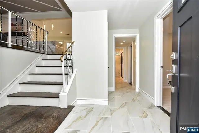 a view of a hallway with wooden floor and entryway