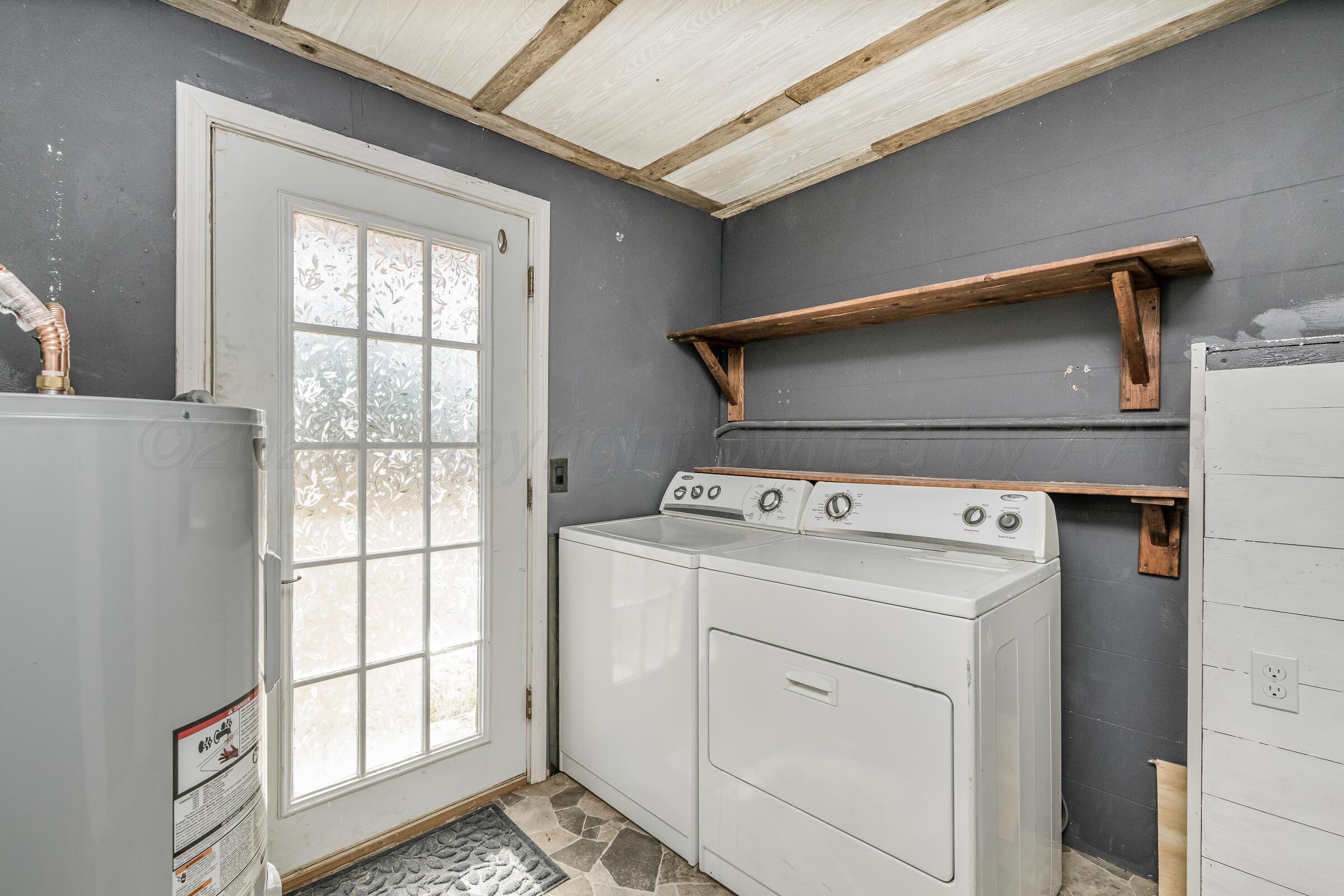 4429 Bowie Street Amarillo, TX 79110 - Photo 17 of 20 a utility room with dryer and washer