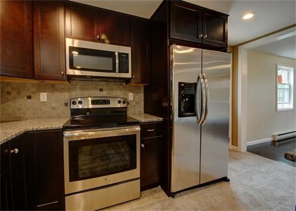 19 Zuell Hill Road Monson, MA 01057 - Photo 6 of 27 a kitchen with a refrigerator stove and microwave