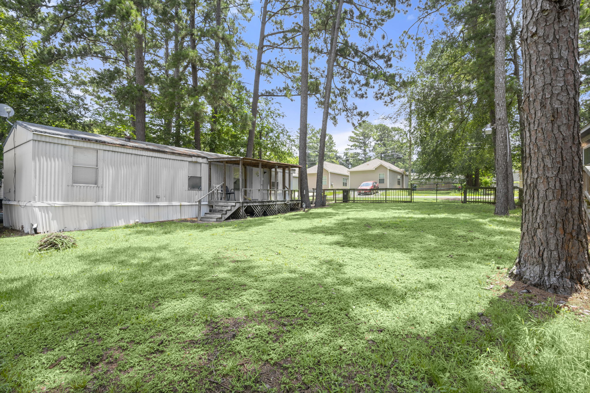 9649 Warm Spring Willis, TX 77318 - Photo 9 of 30 A spacious backyard provides ample green space, perfect for outdoor activities.