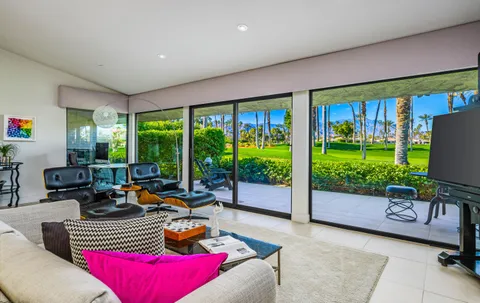 a living room with furniture large window and a fireplace