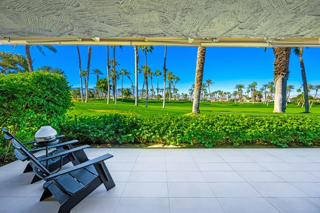 a view of a chairs and table in the patio