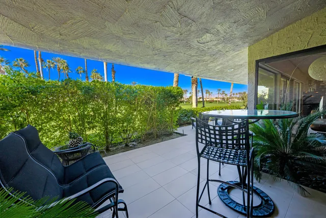 a living room with furniture a dining table and kitchen view