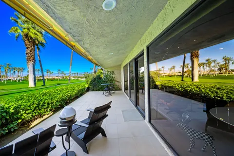 a large kitchen with kitchen island a table and chairs in it